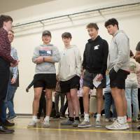 high school students interacting with a laser project